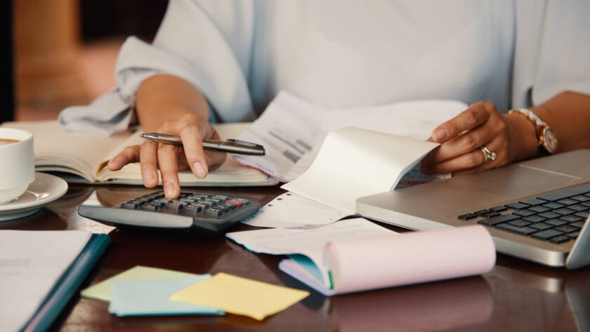 Professional tax consultant in Islamabad analyzing financial reports and calculations with clients in an office setting.
